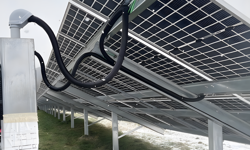 Underside view of ground-mounted solar panels at Advanced Biotech in Oneonta, NY, showing structural racking system and electrical conduit wiring.